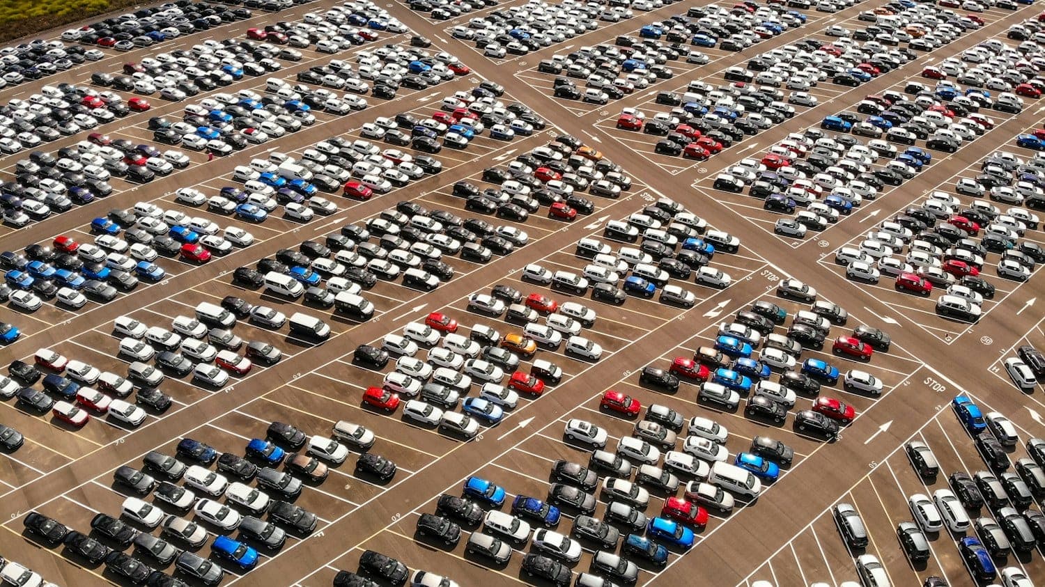 Rows of parked cars Aerial view of hundreds of cars parked in rows
