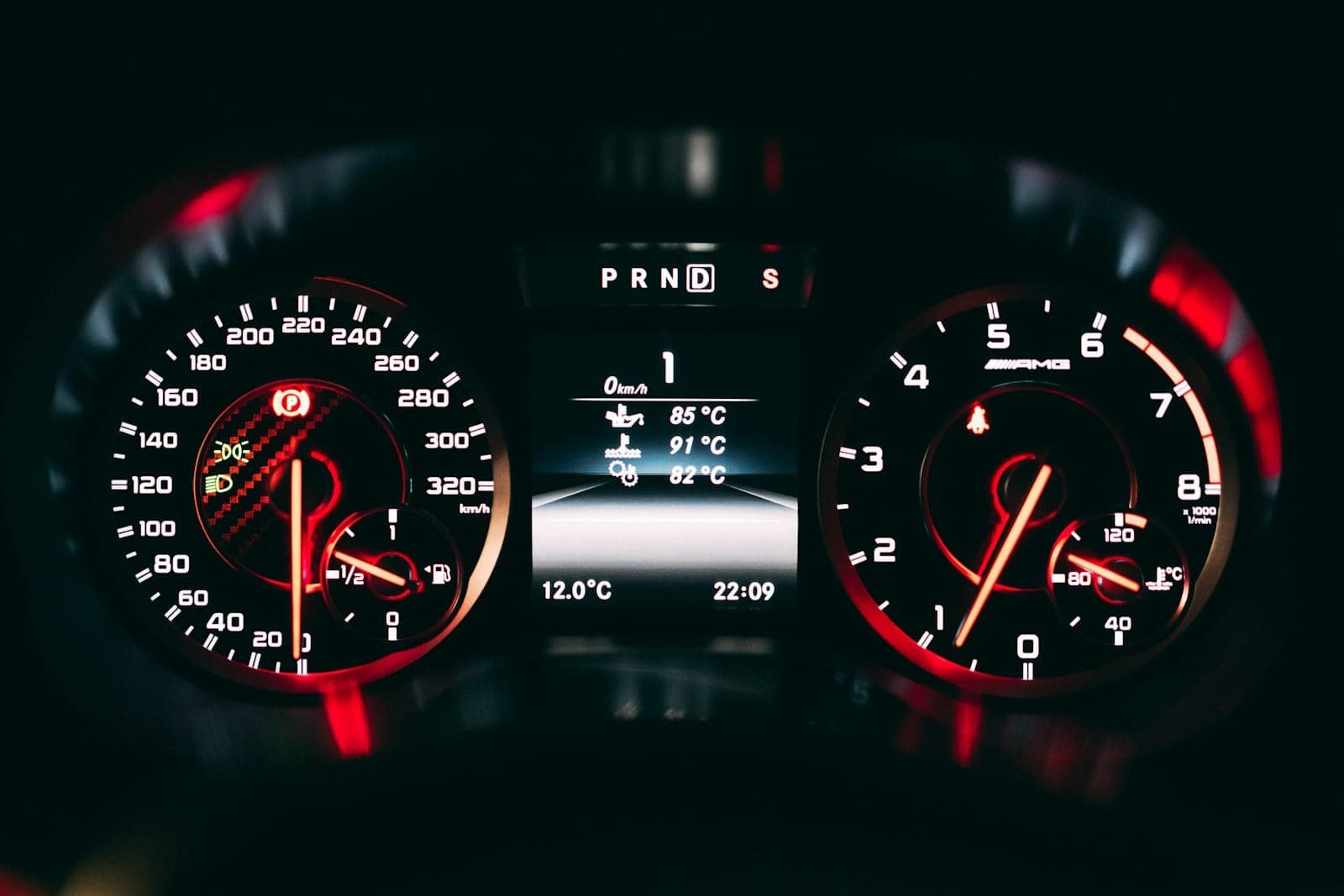 Red-lit instrument cluster Red-lit speedometer and tachometer in a car's instrument cluster