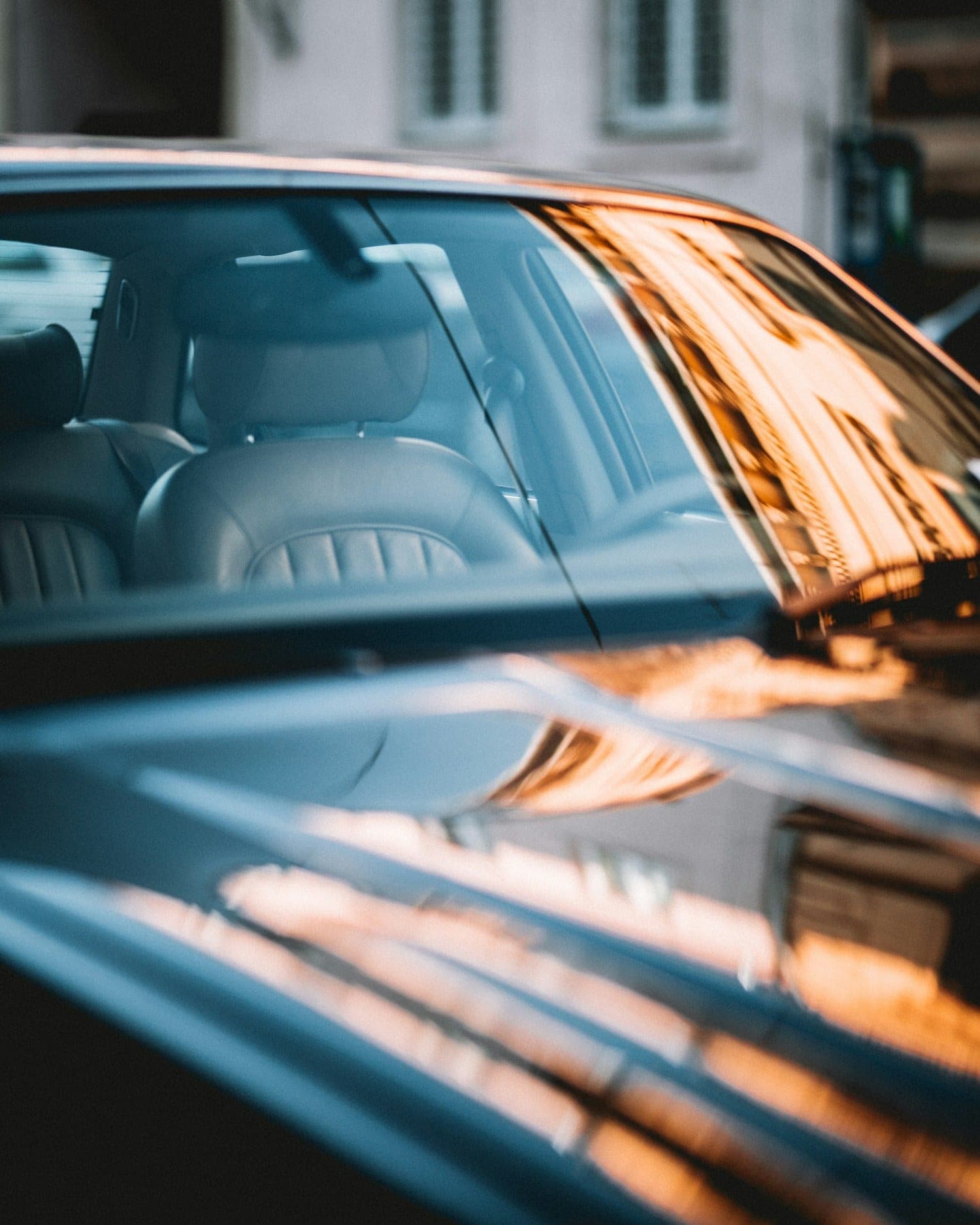 Tinted car window Dark tinted car window reflecting warm evening light